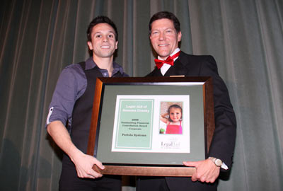 Ryan Miller accepts the 2009 Corporate Financial Contribution award on behalf of Portola Systems from President Peter DeGolia